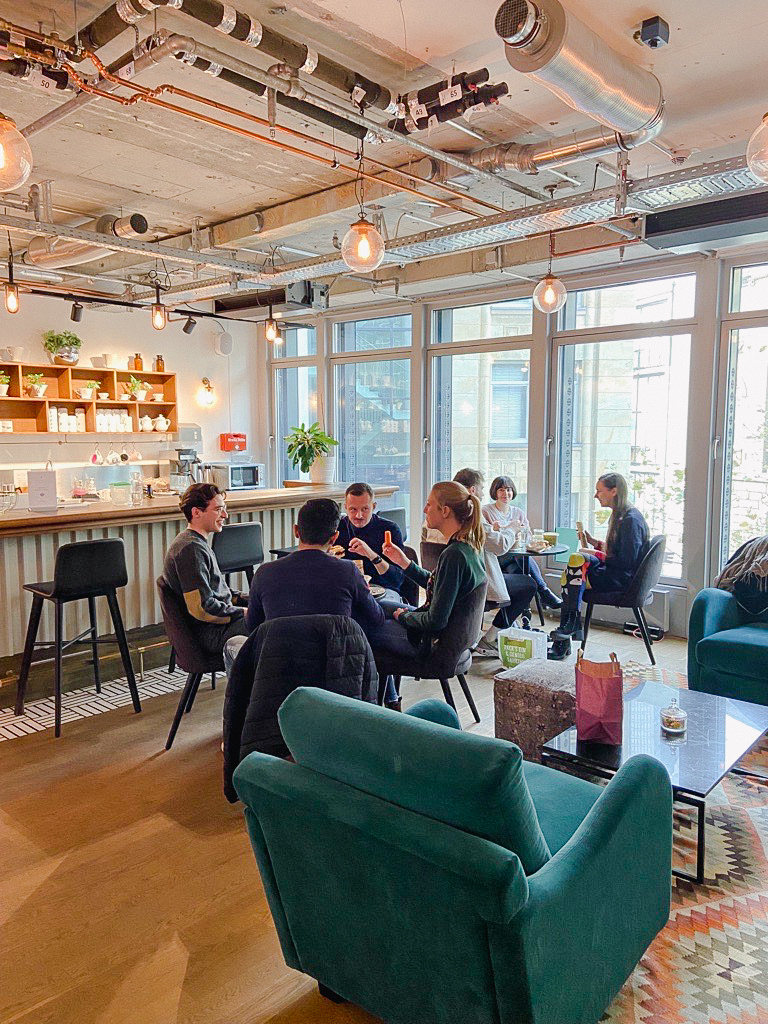 office with kitchen and colleague eating together