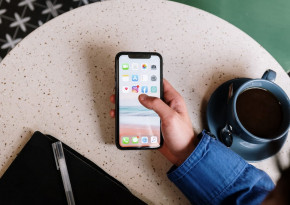 Person taking a picture of a pastry they are holding