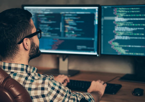 Man sitting at a desk programming